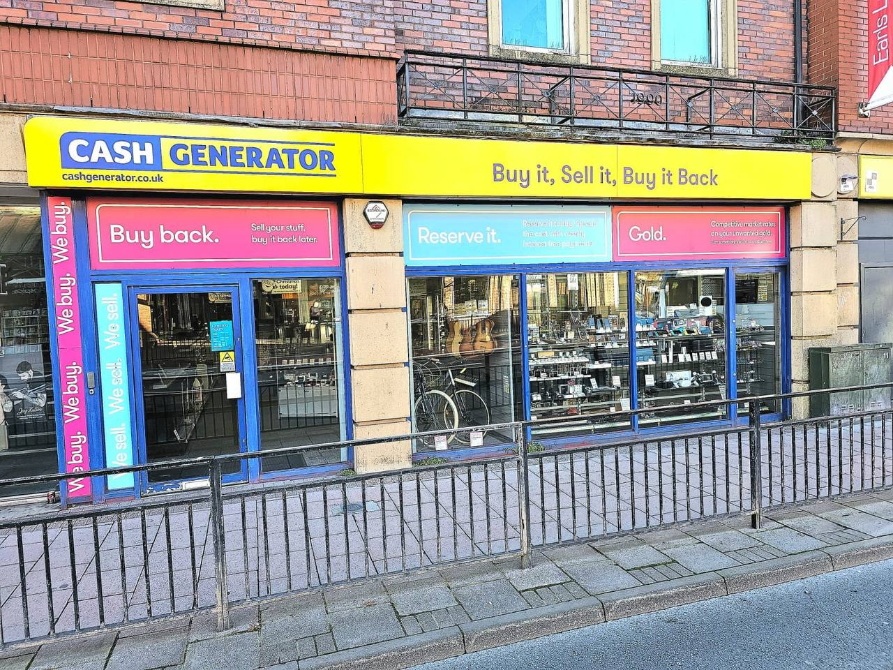 Cash Generator Carlisle entrance with its yellow sign and blue doorway at 48 Lowther Street